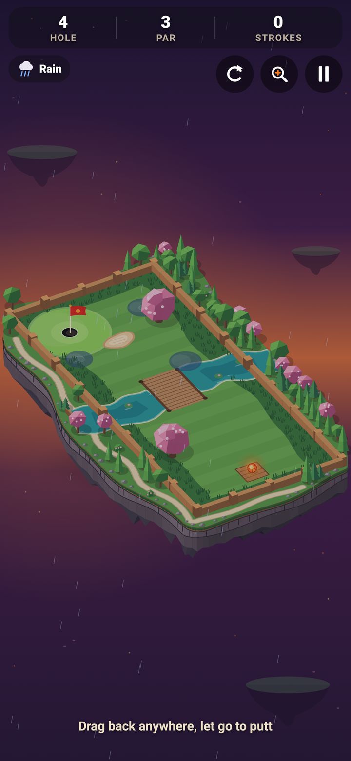 Mini Golf Lily Crossing in the rain: a winding stream with a little footbridge across the fairway and a sand bunker near the cup